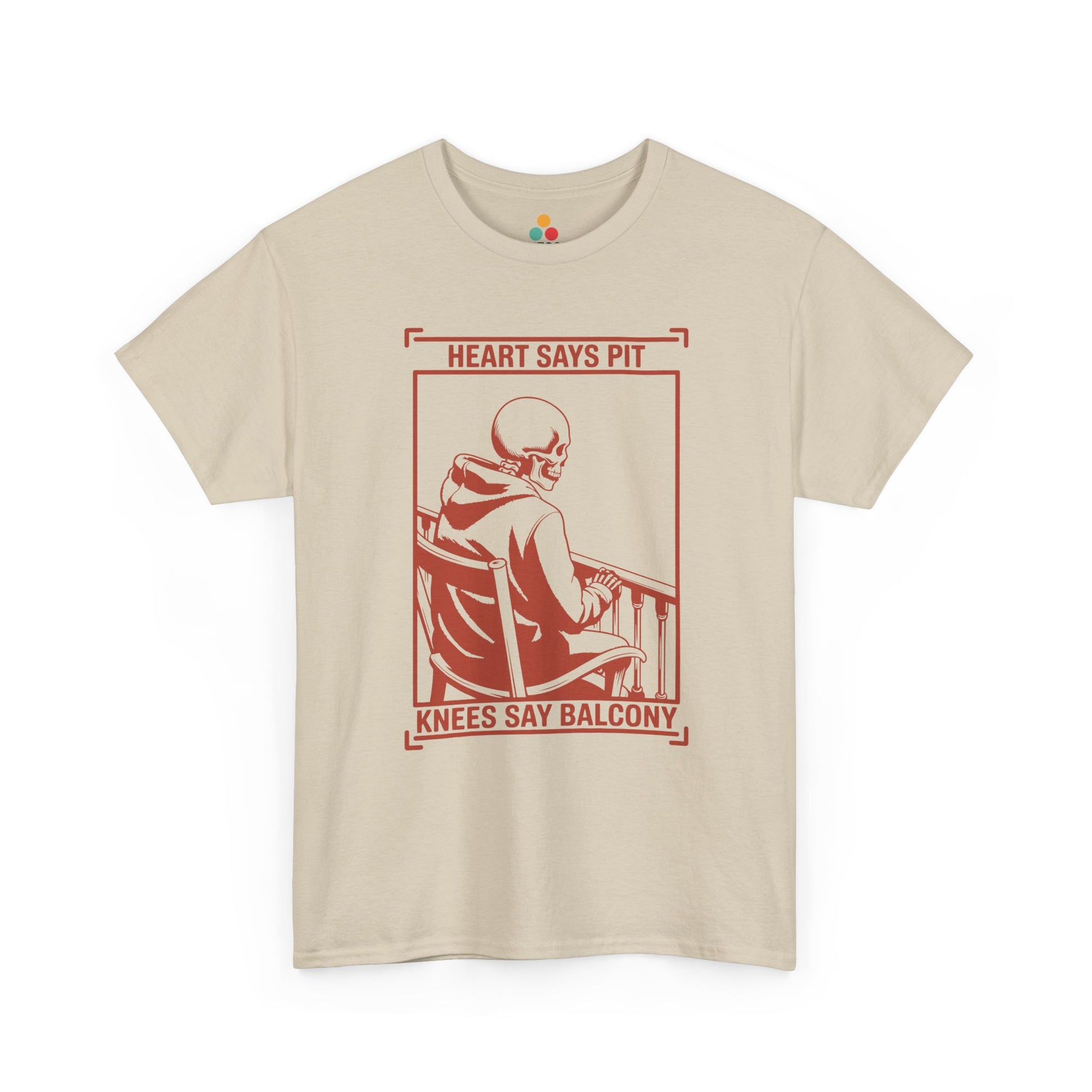  Beige/sand t-shirt mockup with “Heart Says Pit Knees Say Balcony” skeleton concert quote graphic on front.
