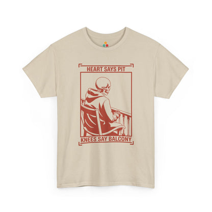  Beige/sand t-shirt mockup with “Heart Says Pit Knees Say Balcony” skeleton concert quote graphic on front.
