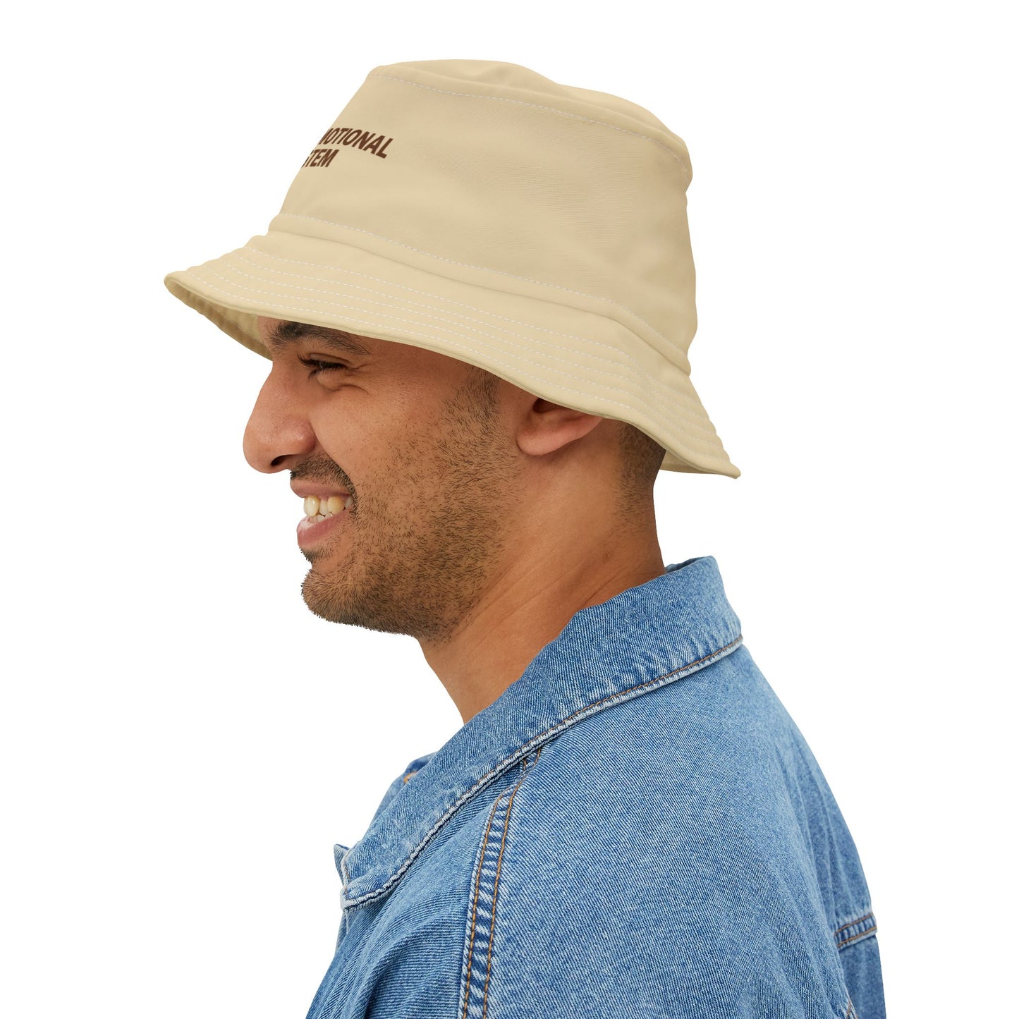 Beige bucket hat with funny text 'CAFFEINE: MY EMOTIONAL SUPPORT SYSTEM' on a white background. TEEZOCA