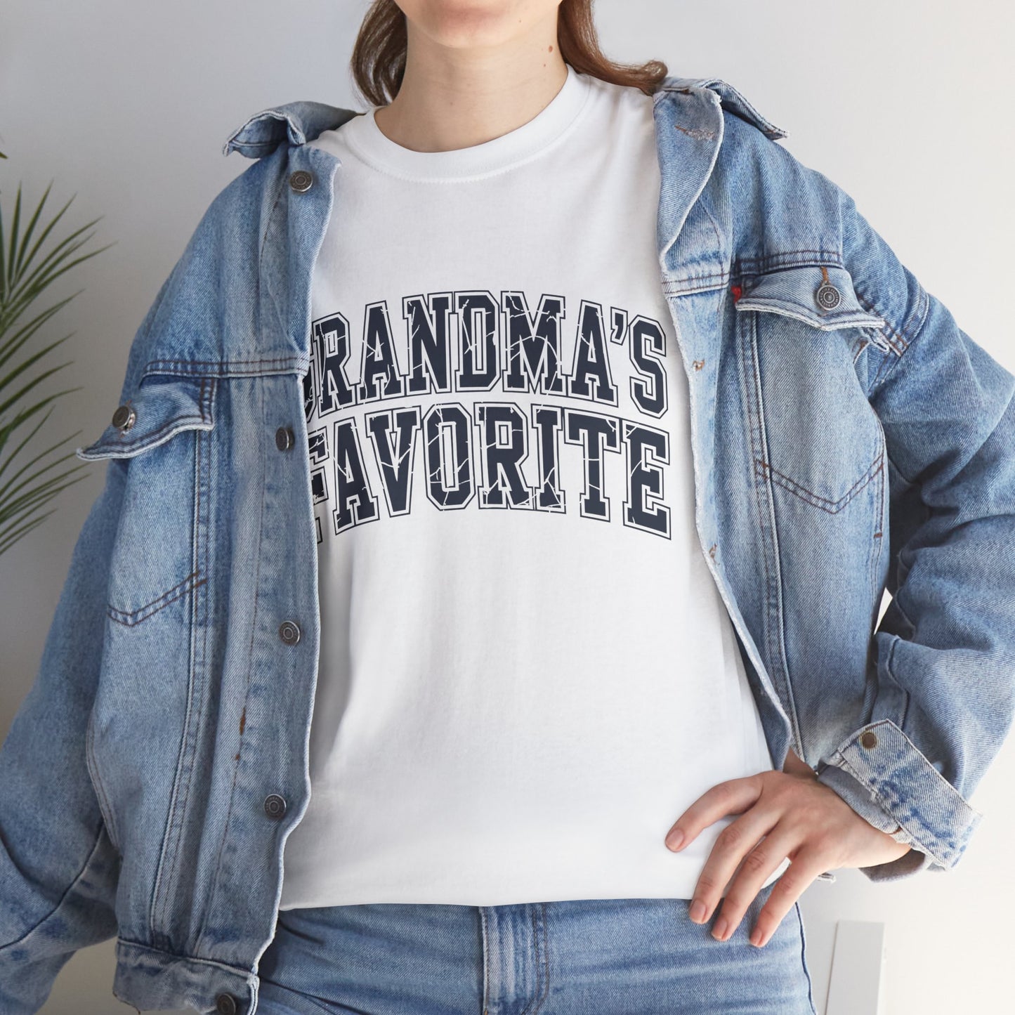 Woman in a denim jacket layering a TEEZOCA “Grandma’s Favorite” grandkid shirt.