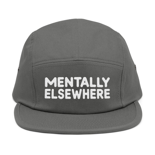 Gray cap with 'Mentally Elsewhere' text on a white background. Mentally Elsewhere embroidered text design on five-panel cap. TEEZOCA