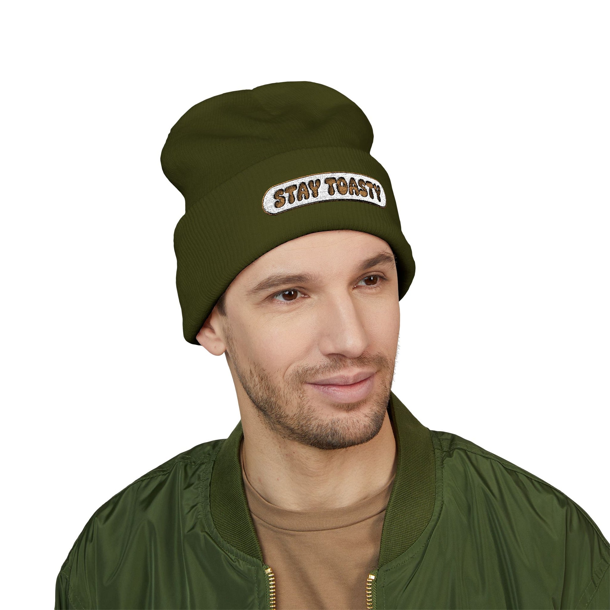 Man wearing a green beanie with 'STAY TOASTY!' text on a white background
