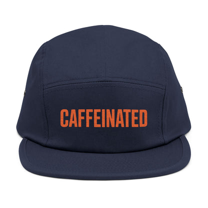 Navy blue cap with 'CAFFEINATED' in orange on a white background. Caffeinated bold typography graphic design in orange. TEEZOCA