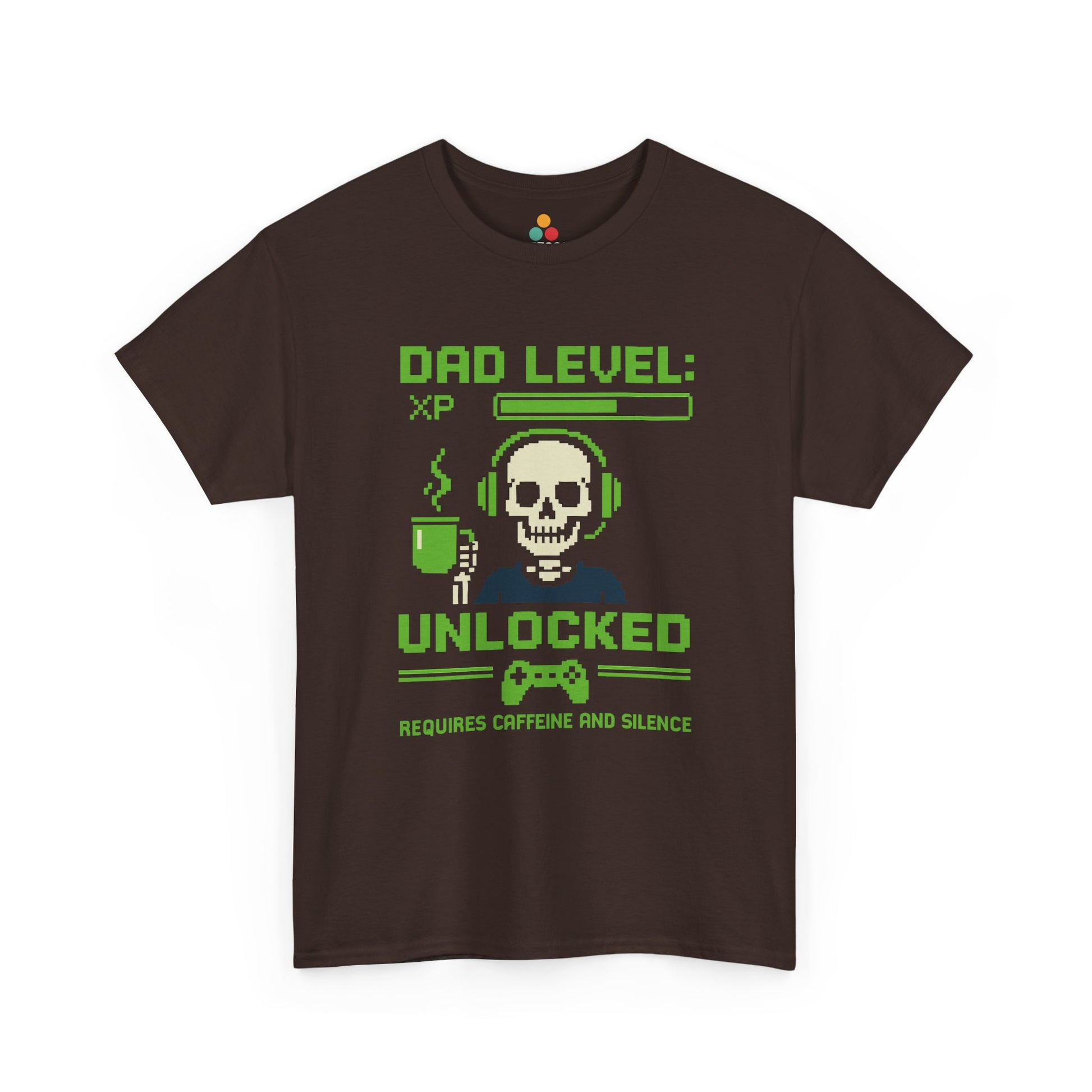“Brown gamer dad tee featuring pixel skull with headset, steaming mug, and ‘Dad Level Unlocked’ text, flat front.”

