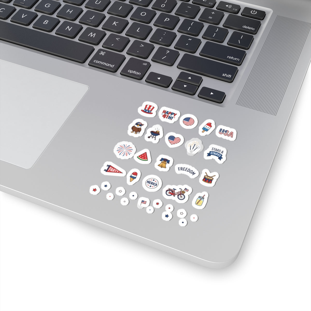 A secondary angle view of the silver laptop tracking pad area showcasing the durable TEEZOCA flag sticker mega bundle.