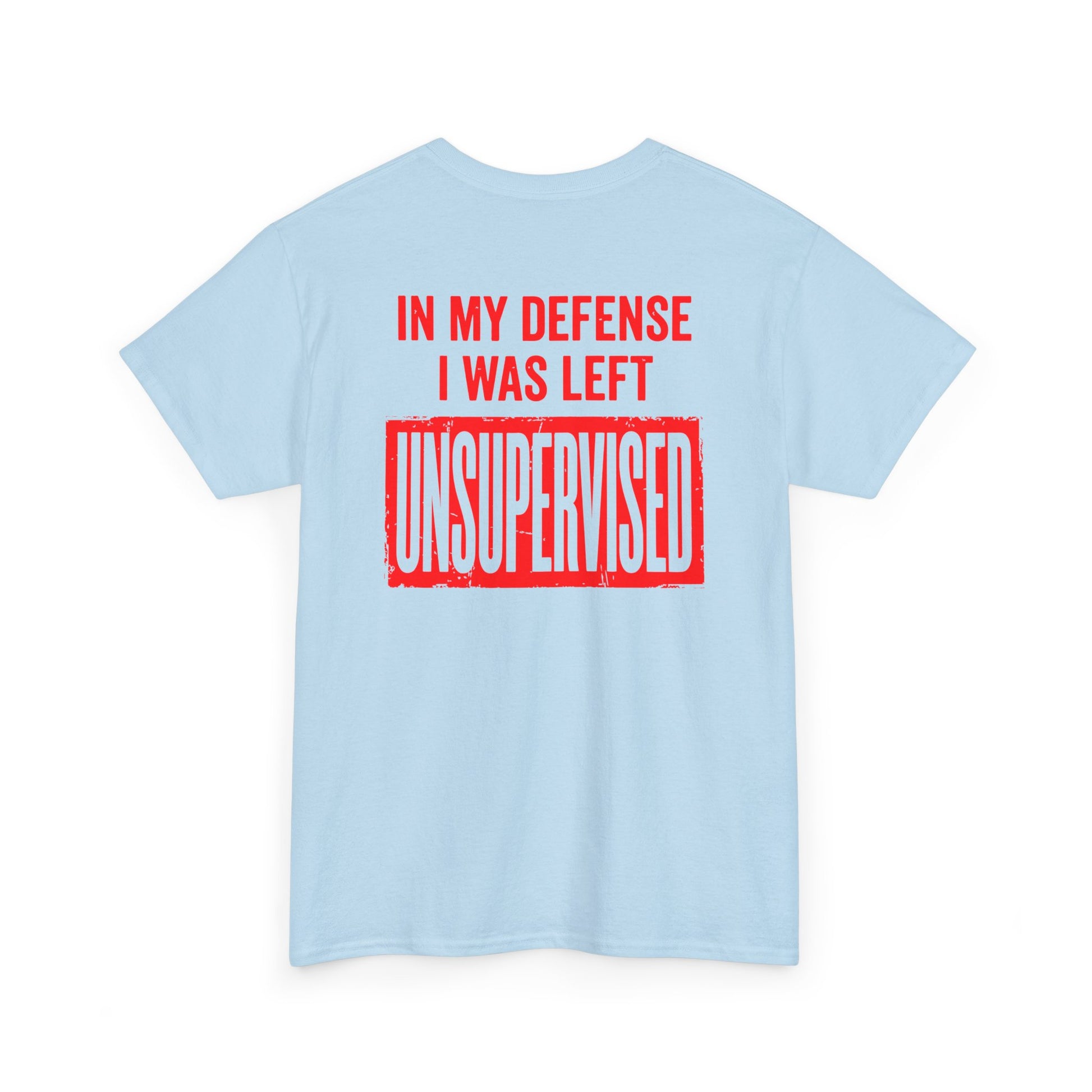 Back Print of a Light Blue T-shirt featuring the bold red and cream quote “In My Defense I Was Left Unsupervised,” a funny back print statement tee with retro typography, sarcastic quote shirt, witty adult humor graphic, dry humor novelty apparel, bold statement t-shirt, and playful sarcasm design for fans of funny quote shirts.
