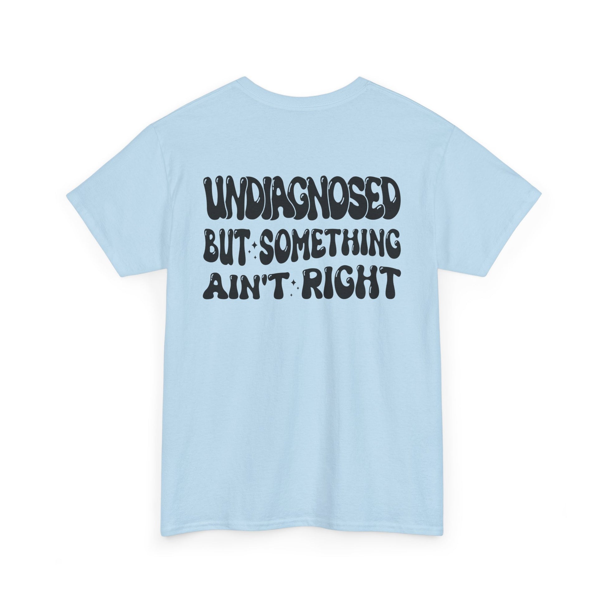 Back Print of a Light Blue T-shirt featuring the viral meme phrase "Undiagnosed But Something Ain't Right" in bold wavy retro typography, a trending funny mental health meme shirt, unhinged humor tee, therapy meme graphic, and relatable back print statement design.
