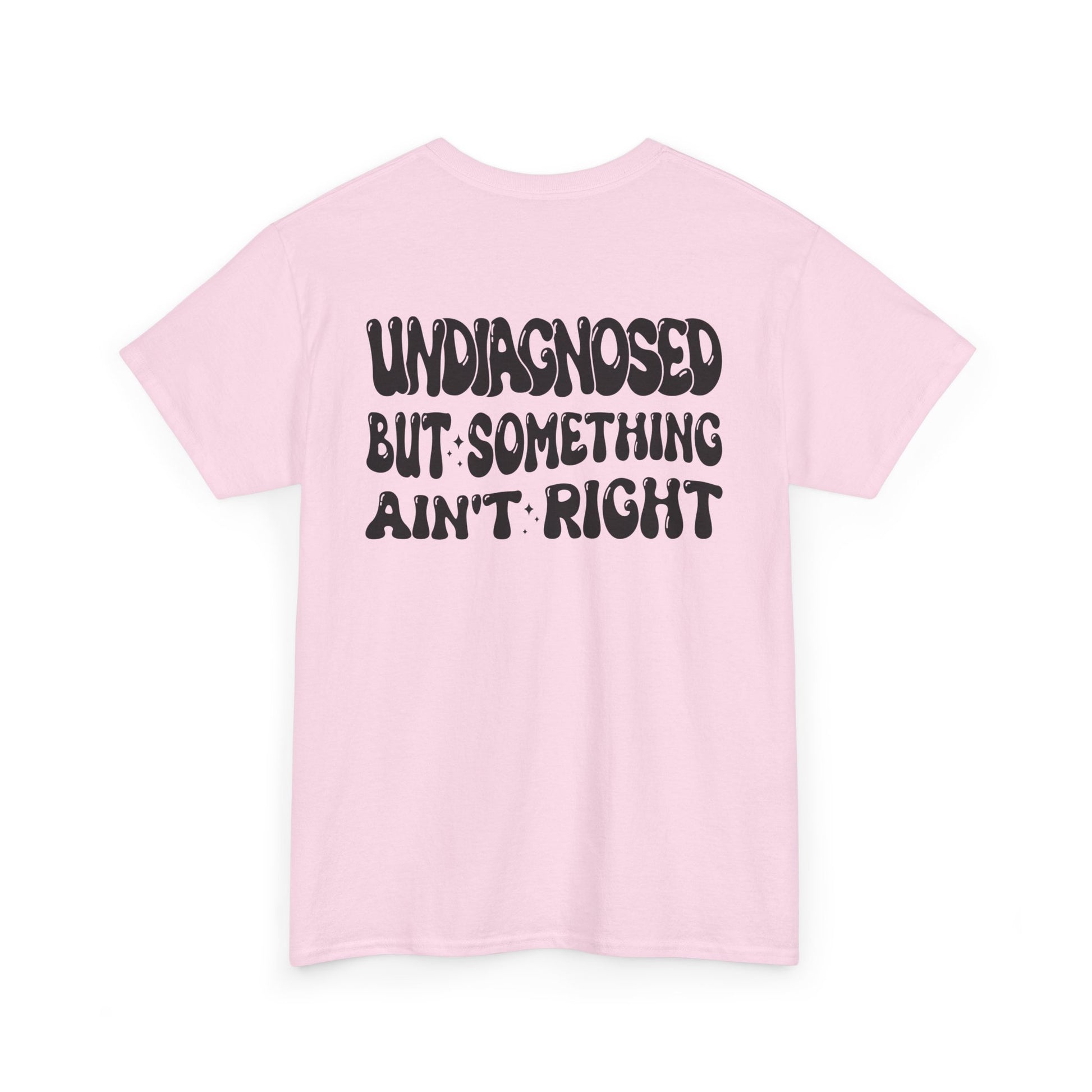 Back Print of a Light Pink T-shirt featuring the viral meme phrase "Undiagnosed But Something Ain't Right" in bold wavy retro typography, a trending funny mental health meme shirt, unhinged humor tee, therapy meme graphic, and relatable back print statement design.

