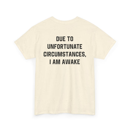 Back Print of a Natural T-shirt featuring bold black text reading "Due To Unfortunate Circumstances, I Am Awake," funny back print sarcastic quote shirt, not a morning person tee, dry humor graphic shirt, and blunt statement design.
