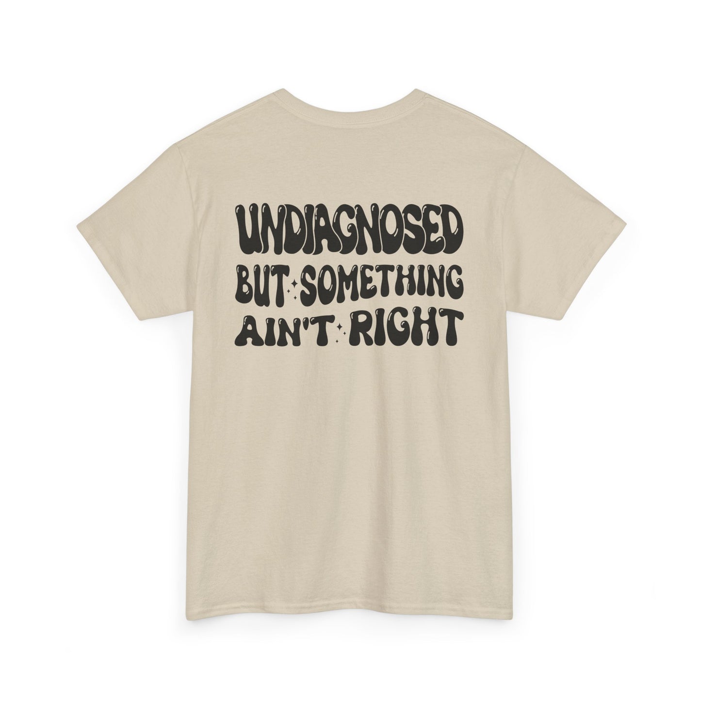 Back Print of a Sand T-shirt featuring the viral meme phrase "Undiagnosed But Something Ain't Right" in bold wavy retro typography, a trending funny mental health meme shirt, unhinged humor tee, therapy meme graphic, and relatable back print statement design.

