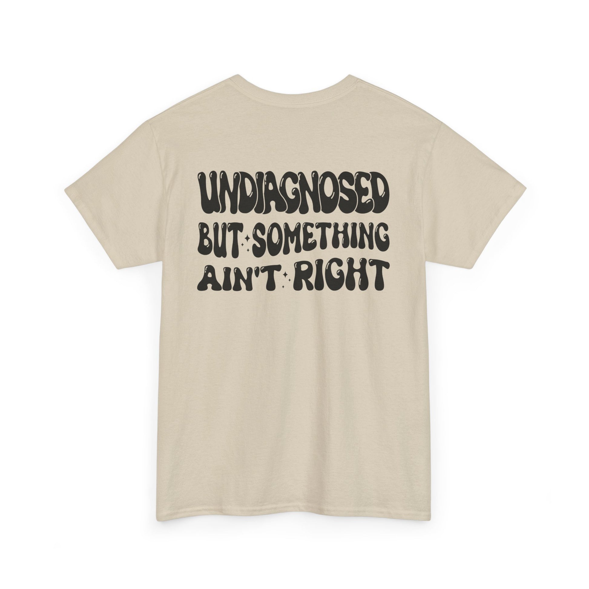 Back Print of a Sand T-shirt featuring the viral meme phrase "Undiagnosed But Something Ain't Right" in bold wavy retro typography, a trending funny mental health meme shirt, unhinged humor tee, therapy meme graphic, and relatable back print statement design.

