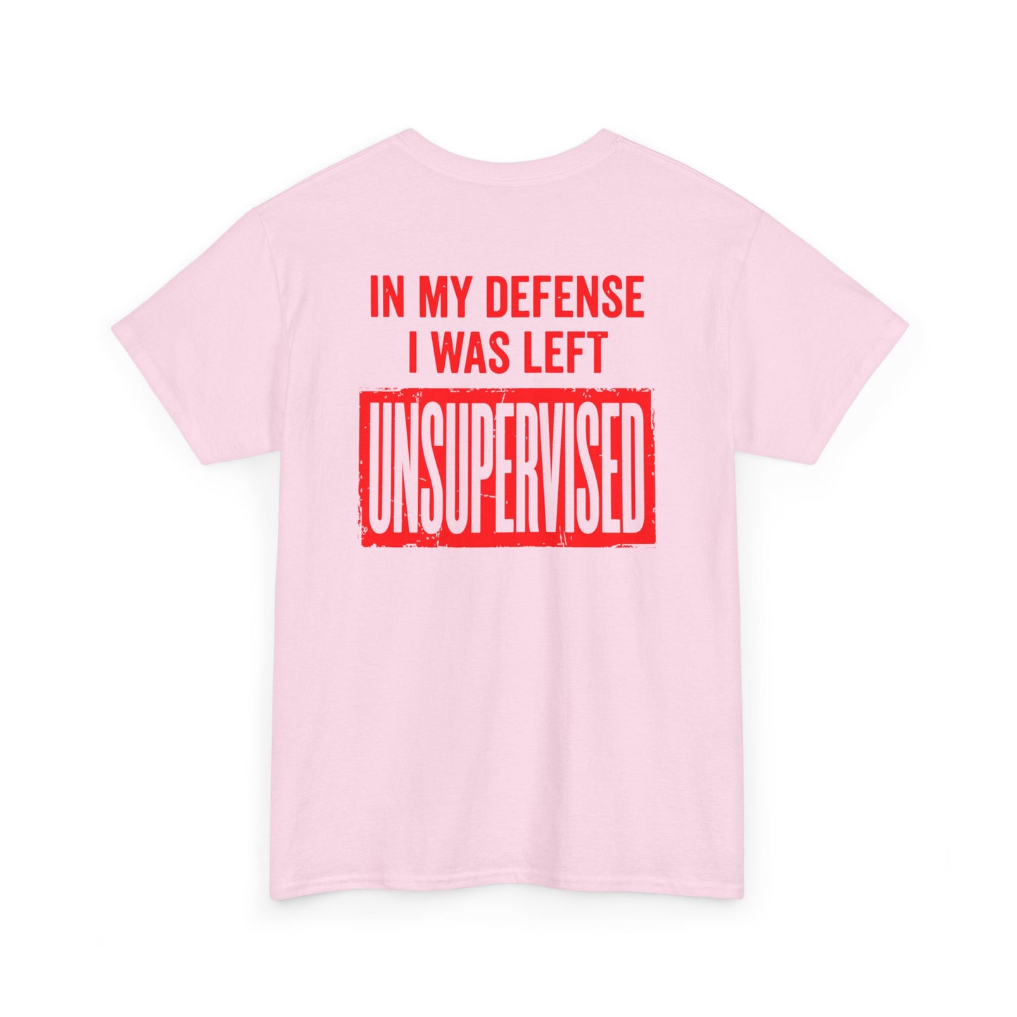 Back Print of a light pink T-shirt featuring the bold red and cream quote “In My Defense I Was Left Unsupervised,” a funny back print statement tee with retro typography, sarcastic quote shirt, witty adult humor graphic, dry humor novelty apparel, bold statement t-shirt, and playful sarcasm design for fans of funny quote shirts.
