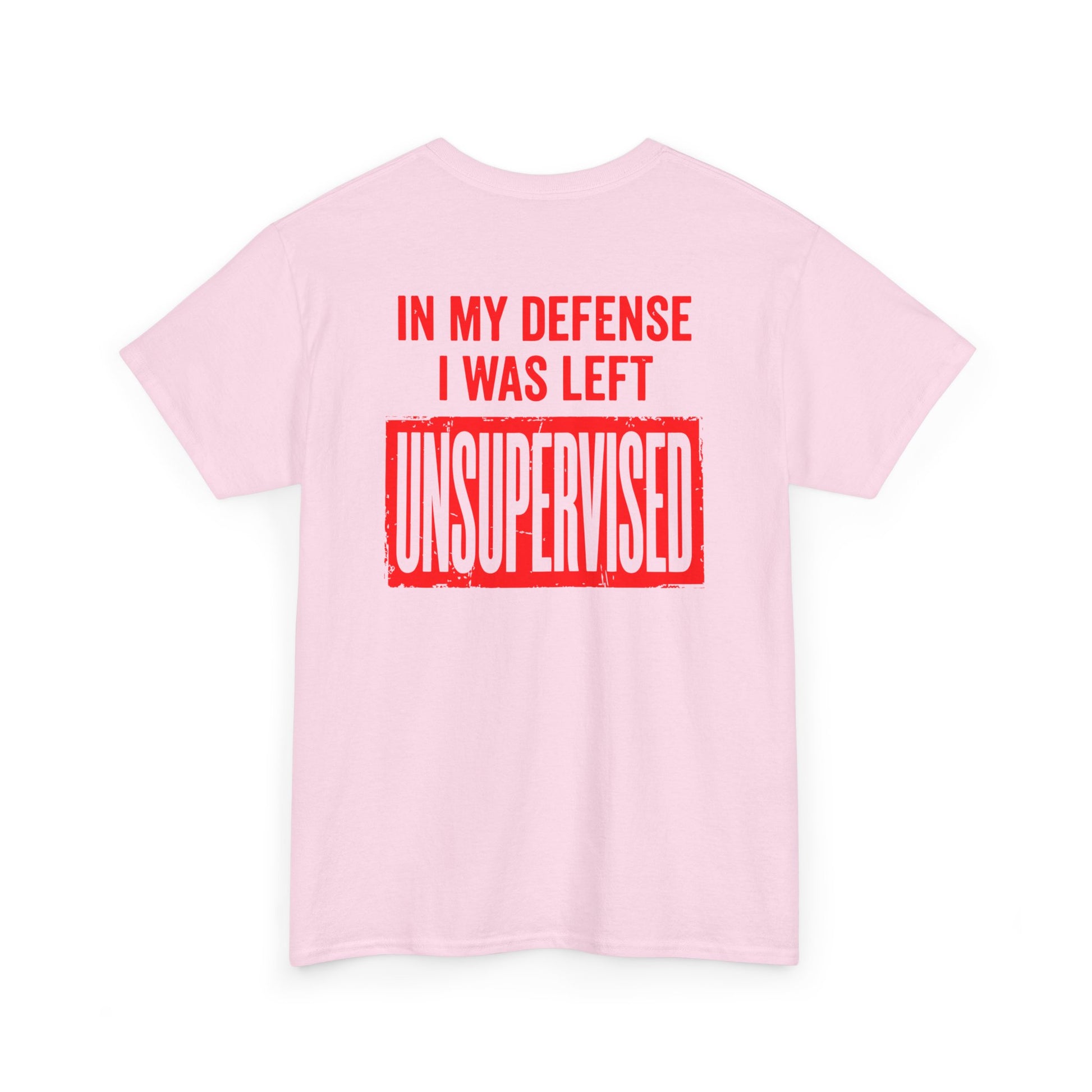 Back Print of a light pink T-shirt featuring the bold red and cream quote “In My Defense I Was Left Unsupervised,” a funny back print statement tee with retro typography, sarcastic quote shirt, witty adult humor graphic, dry humor novelty apparel, bold statement t-shirt, and playful sarcasm design for fans of funny quote shirts.
