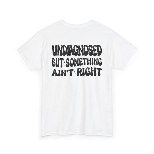 Back Print of a white T-shirt featuring the viral meme phrase "Undiagnosed But Something Ain't Right" in bold wavy retro typography, a trending funny mental health meme shirt, unhinged humor tee, therapy meme graphic, and relatable back print statement design.

