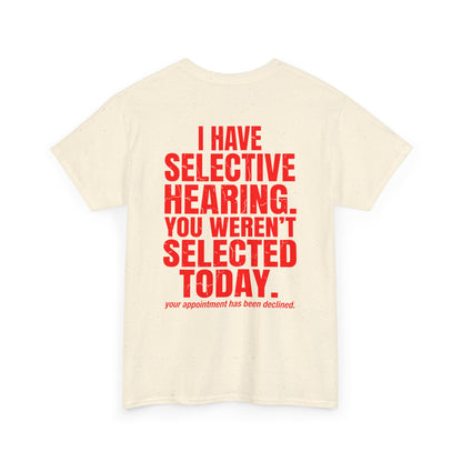 Back print of a biege T-shirt with bold red text reading “I Have Selective Hearing You Weren’t Selected Today” and smaller sarcastic text below.

