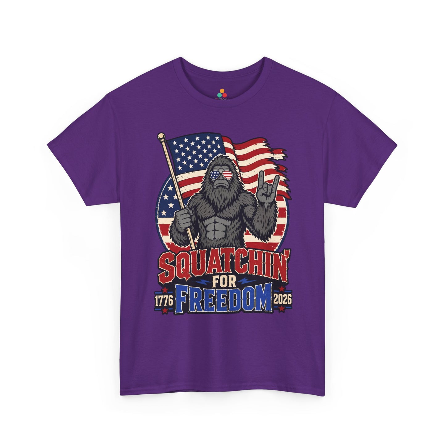 Bigfoot Shirt Squatchin' For Freedom 1776 Patriotic T-shirt Gift | TEEZOCA 4th of July Bigfoot T-shirt showing a Sasquatch with an American flag, freedom lettering, and rugged outdoor style.
