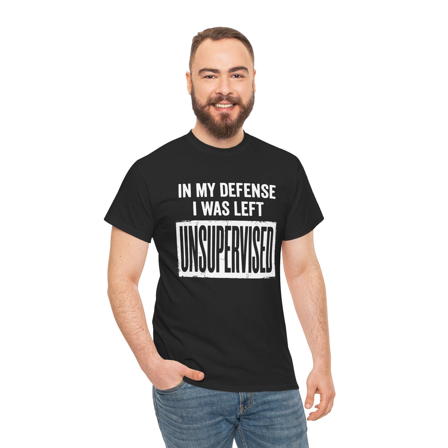 Black T-shirt featuring bold white block typography reading "In My Defense I Was Left Unsupervised" with a highlighted "UNSUPERVISED" text box, funny sarcastic quote shirt, witty statement tee, dry humor graphic tee, and bold novelty quote apparel.