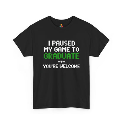 Black TEEZOCA t‑shirt with pixel text “I PAUSED MY GAME TO GRADUATE YOU’RE WELCOME” in white and green shown flat.