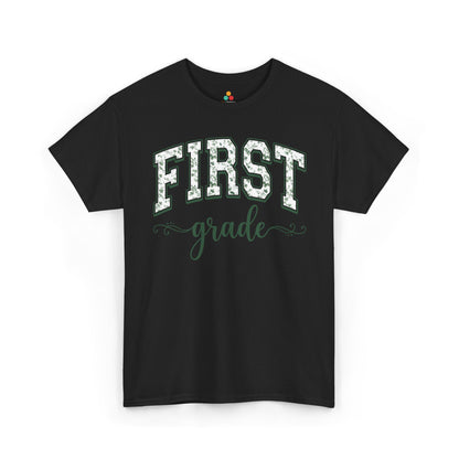 Black t-shirt with 'FIRST grade' text on a white background. TEEZOCA first grade teacher shirt featuring sage floral varsity lettering, a cute back to school tee for teachers.
