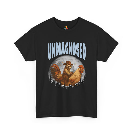 "Black t‑shirt with retro western lettering reading 'Undiagnosed' above illustrated cowboy and raccoon in desert sunset scene, flat front view."

