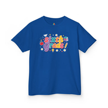 Blue t-shirt with 'Sixth Grade!' text and graphics on a white background. TEEZOCA t-shirt showing a paper airplane, light bulb, apple, books, and stars for a 6th grade shirt for boys.