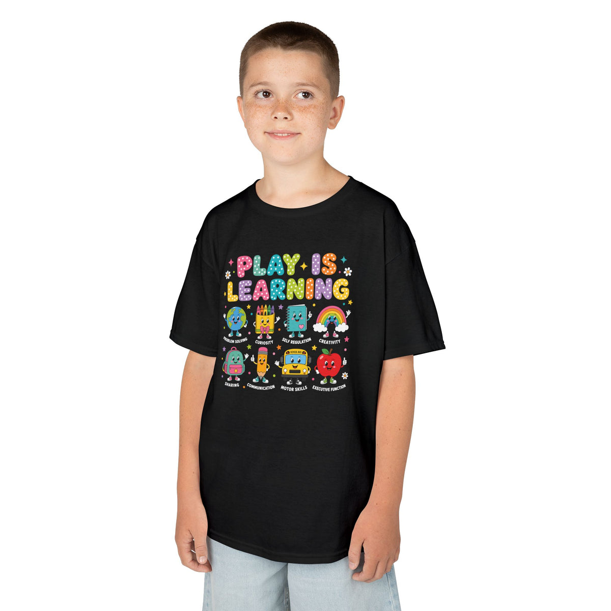 Boy wearing a black TEEZOCA Play Is Learning kids t-shirt, a cute back to school shirt for a young learner.
