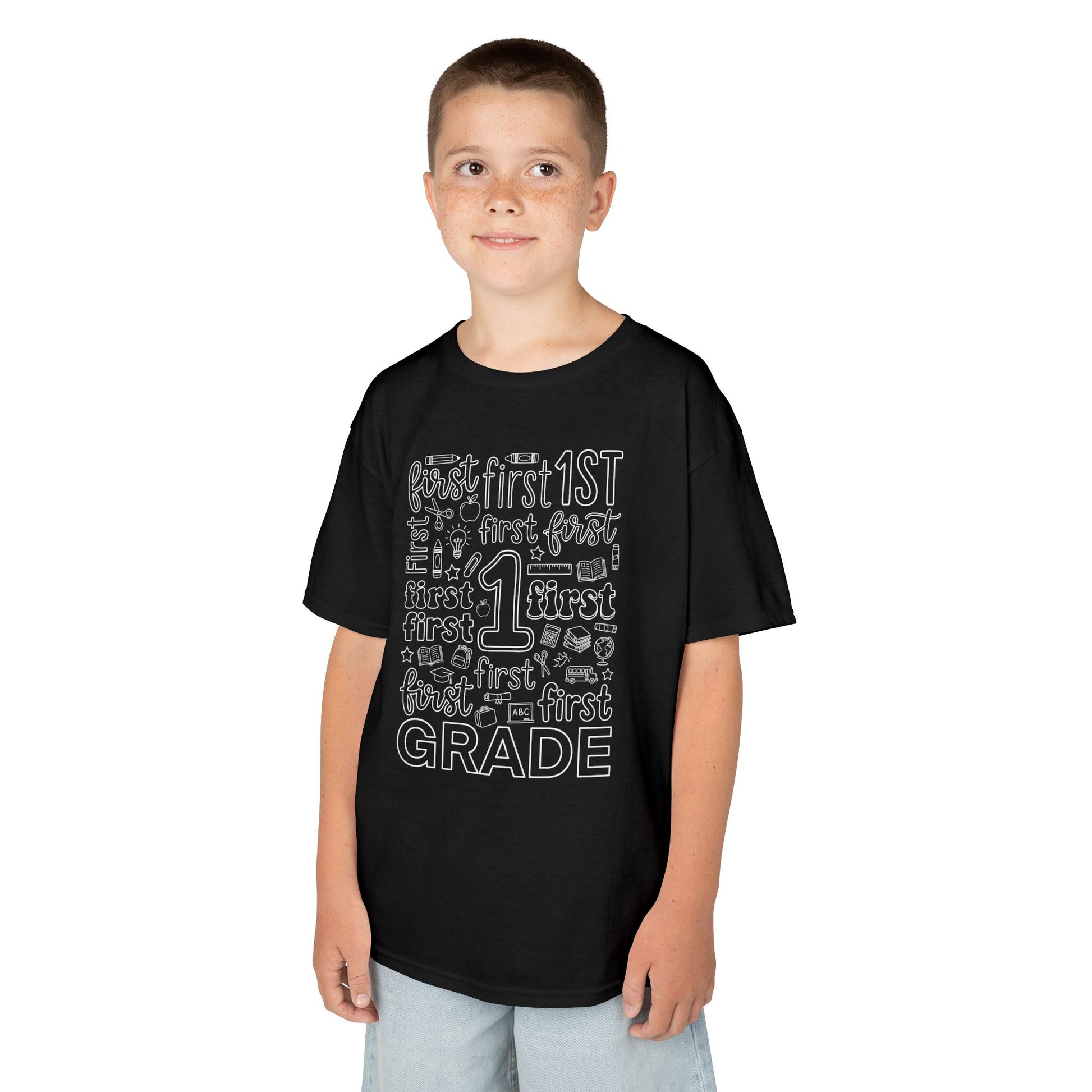 Boy wearing a black TEEZOCA first grade typography kids t-shirt, a cute back to school shirt for a new first grader.
