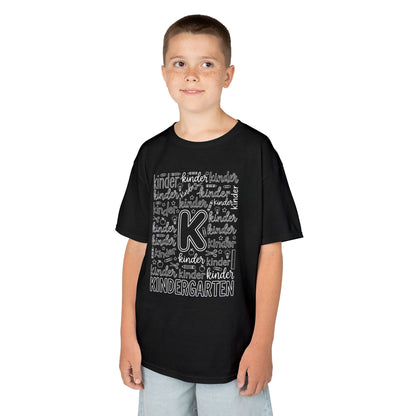 Boy wearing a black TEEZOCA kindergarten typography kids t-shirt, a cute back to school shirt for a new kindergartener.
