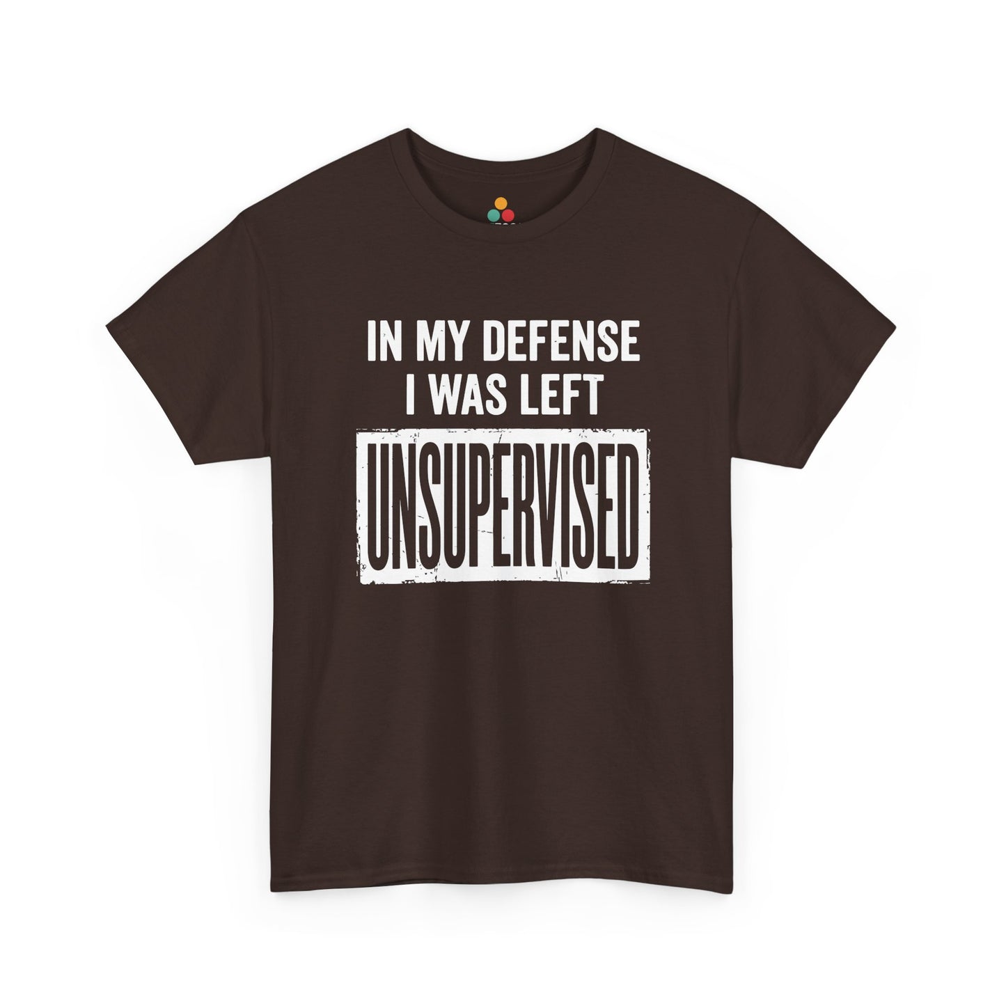 Brown T-shirt featuring bold white block typography reading "In My Defense I Was Left Unsupervised" with a highlighted "UNSUPERVISED" text box, funny sarcastic quote shirt, witty statement tee, dry humor graphic tee, and bold novelty quote apparel.