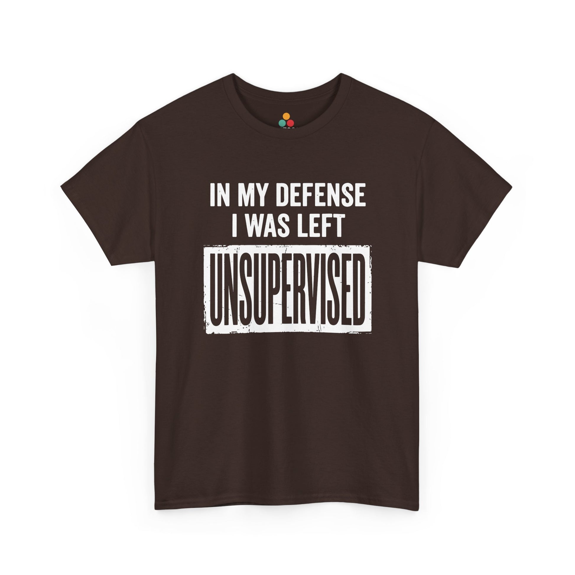 Brown T-shirt featuring bold white block typography reading "In My Defense I Was Left Unsupervised" with a highlighted "UNSUPERVISED" text box, funny sarcastic quote shirt, witty statement tee, dry humor graphic tee, and bold novelty quote apparel.