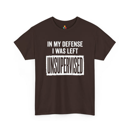 Brown T-shirt featuring bold white block typography reading "In My Defense I Was Left Unsupervised" with a highlighted "UNSUPERVISED" text box, funny sarcastic quote shirt, witty statement tee, dry humor graphic tee, and bold novelty quote apparel.