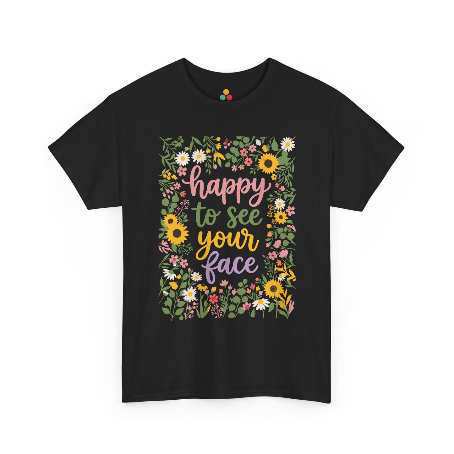 Close-up of a Black T-shirt featuring the phrase “Happy to See Your Face” in pastel lettering framed by a floral border with sunflowers and wildflowers.

