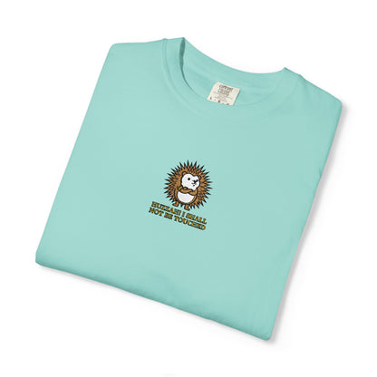 Close-up of a Chalky Mint Comfort Colors® shirt featuring an embroidered round hedgehog with gold lettering saying "Huzzah! I Shall Not Be Touched."

