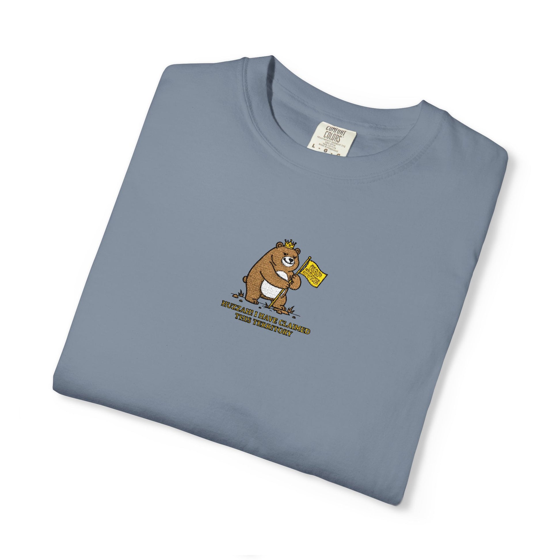 Close-up of a Comfort Colors® Bay mint shirt featuring an embroidered grumpy bear holding a "Do Not Enter" flag with the saying "Huzzah! I Have Claimed This Territory.

