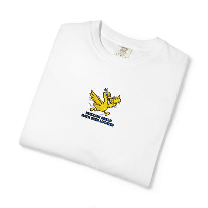 Close-up of a Comfort Colors® white shirt featuring an embroidered yellow duck carrying bread with the saying “Huzzah! Bread Must Be Located.”

