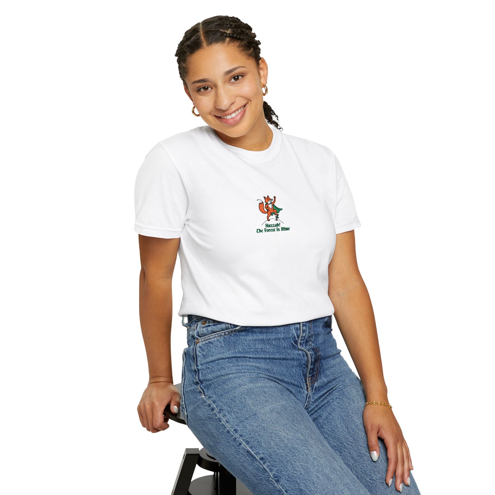 Close-up of a FEAMALE  Model  wearing white Comfort Colors®  
 shirt featuring an embroidered orange fox in a green cape with the saying "Huzzah! The Forest Is Mine."


