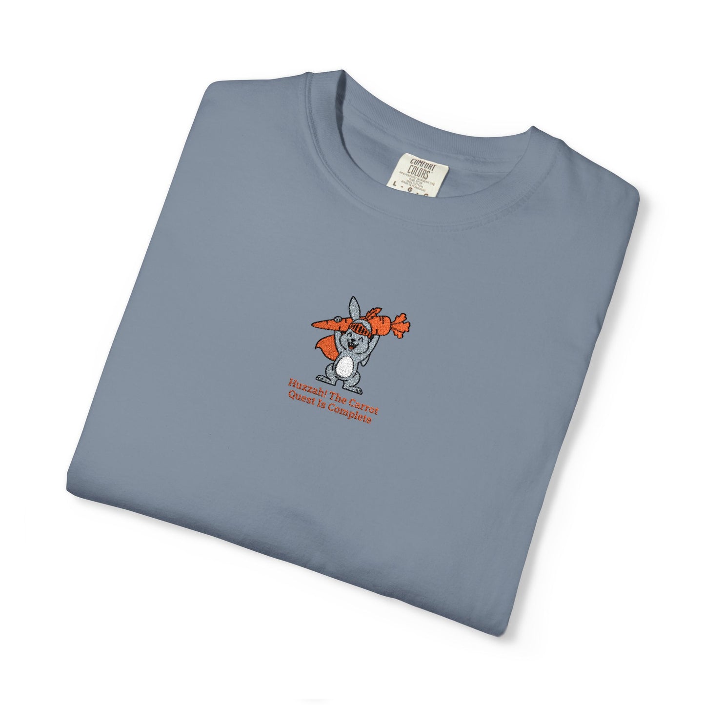  Close-up of a Lagoon Blue  Comfort Colors®  Lagoon Blue shirt featuring a rabbit holding carrots with the saying “Huzzah! The Carrot Quest Is Complete.”

