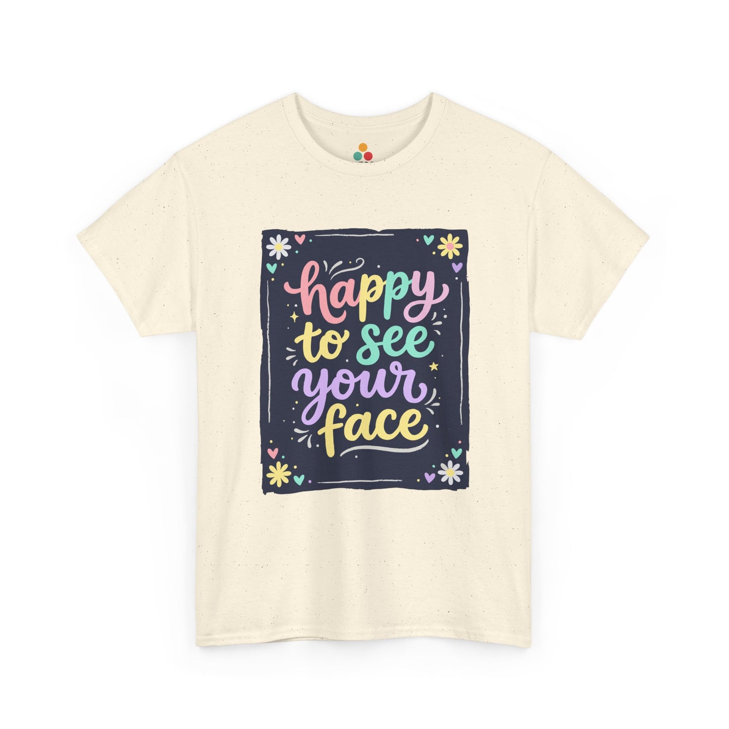 Close-up of a Light BEIGE T-shirt featuring a colorful "Happy to See Your Face" hand-lettered graphic framed with flowers and hearts on a navy background panel.
