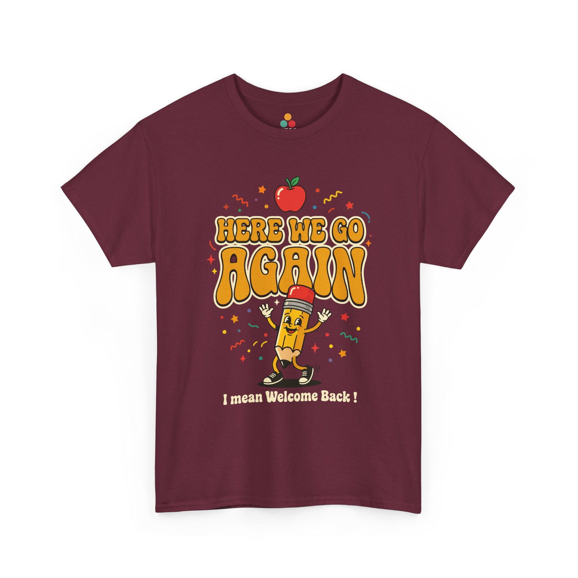 Close-up of a Maroon T-shirt featuring a funny back to school design with the words “Here We Go Again” and “I mean Welcome Back!” plus a red apple and a pencil character.

