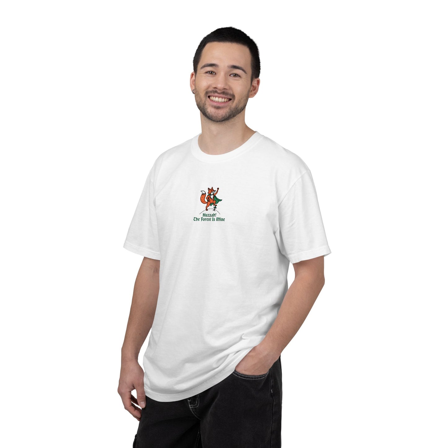 Close-up of a Men  Model  wearing white Comfort Colors®  
 shirt featuring an embroidered orange fox in a green cape with the saying "Huzzah! The Forest Is Mine."

