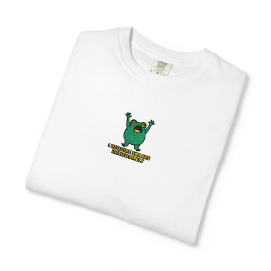 Close-up of a white Comfort Colors® shirt featuring an embroidered green frog meditating under a red mushroom with the saying “Cottagecore Is My Personality.”

