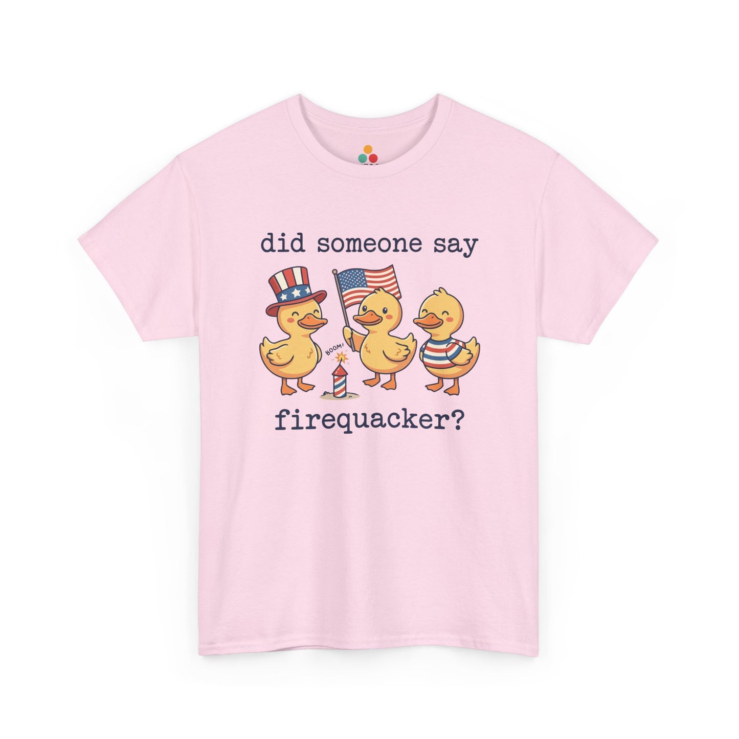  Close-up view of TEEZOCA Pink T-Shirt printed with three patriotic ducks — one in an Uncle Sam hat, one holding an American flag, one in red white and blue stripes — with the text "did someone say firequacker?" and a firecracker illustration, funny 4th of July 2026 graphic tee.

