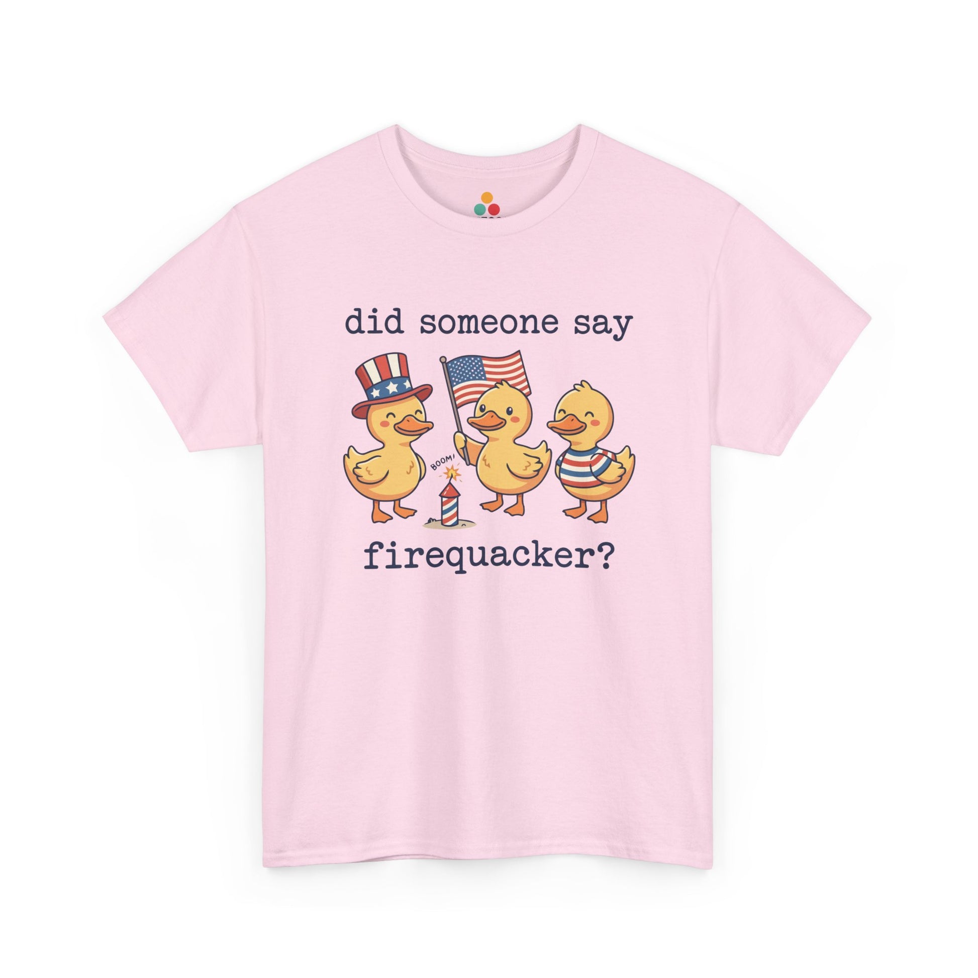  Close-up view of TEEZOCA Pink T-Shirt printed with three patriotic ducks — one in an Uncle Sam hat, one holding an American flag, one in red white and blue stripes — with the text "did someone say firequacker?" and a firecracker illustration, funny 4th of July 2026 graphic tee.

