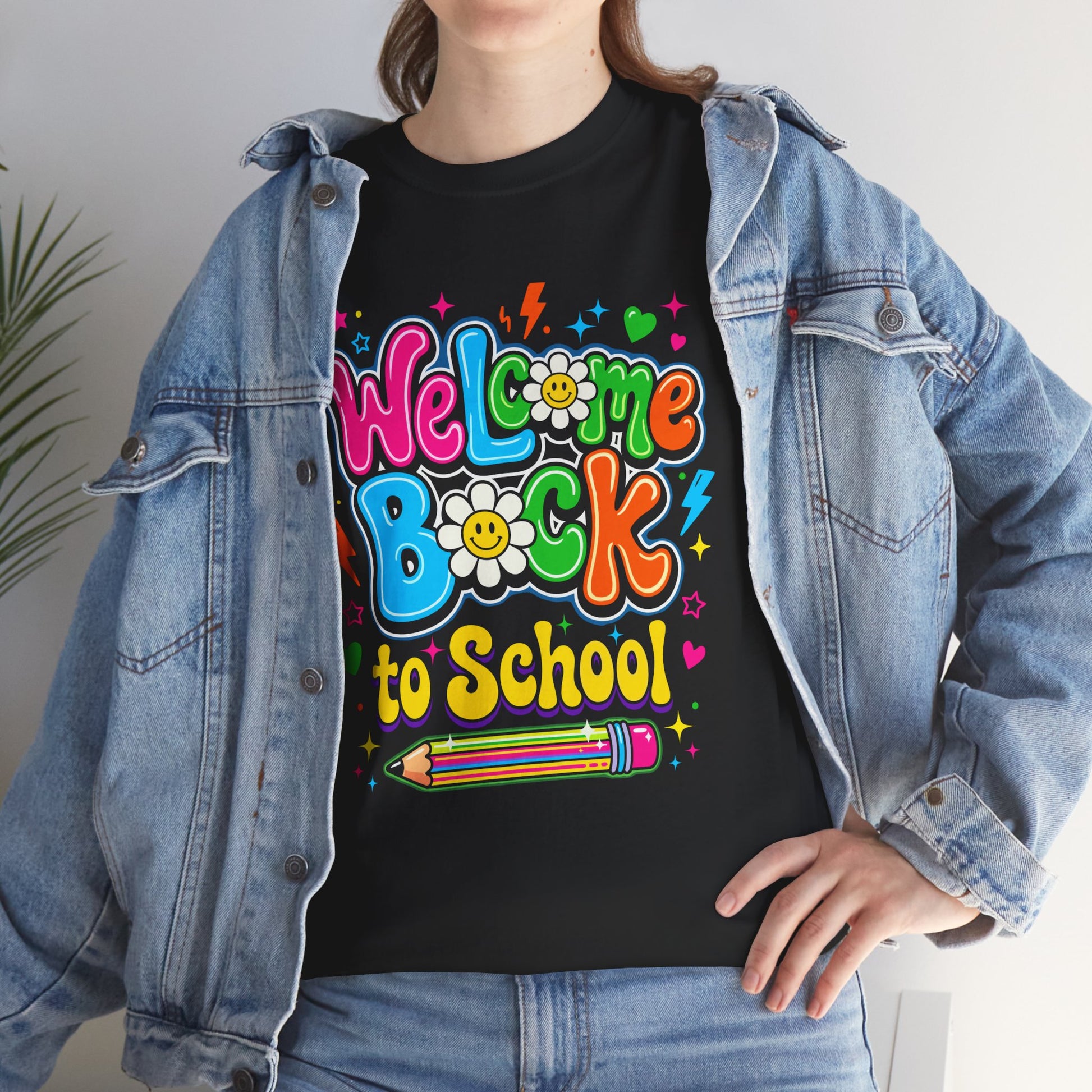 Close up view of FEMAlE Model TEEZOCA Black T-Shirt with colorful “Welcome Back to School” cartoon design featuring smiling flowers, stars, and a pencil on Lifestyle outfits


