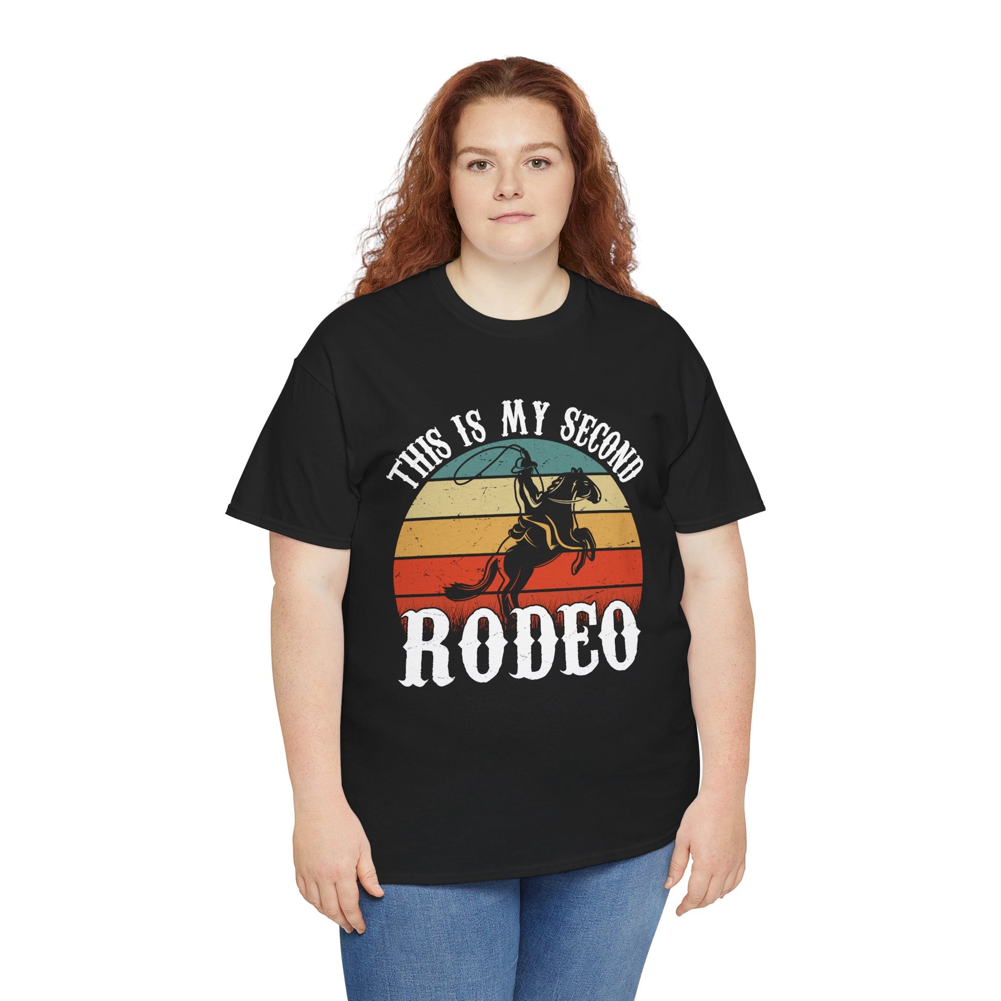 “Female model in Teezoca This Is My Second Rodeo shirt, distressed sunset cowboy graphic, funny western rodeo tee, front”

