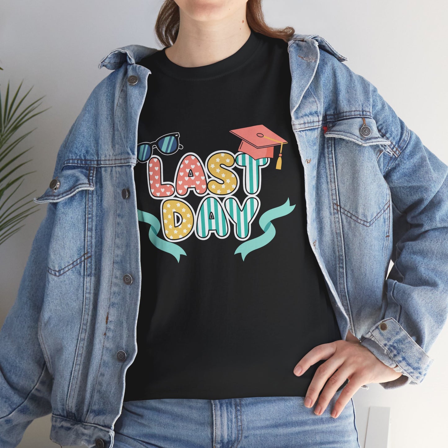 Female model with denim jacket wearing TEEZOCA colorful graduation theme shirt in black.