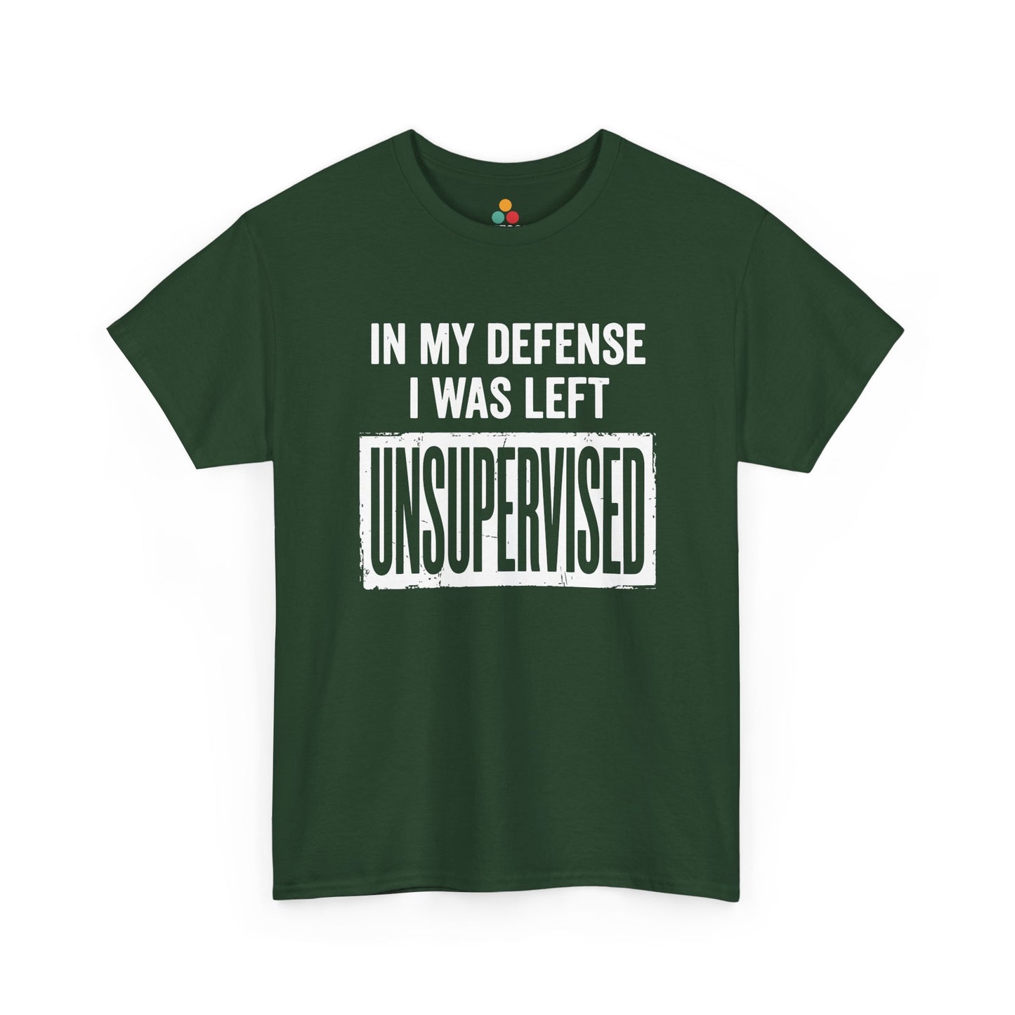 Forest green T-shirt featuring bold white block typography reading "In My Defense I Was Left Unsupervised" with a highlighted "UNSUPERVISED" text box, funny sarcastic quote shirt, witty statement tee, dry humor graphic tee, and bold novelty quote apparel.