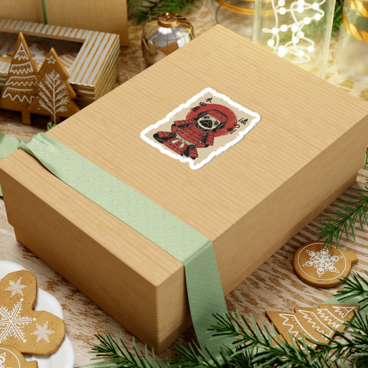 Gift box with a decorative sticker on a festive background with cookies and lights