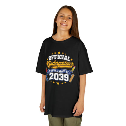 Girl wearing a black TEEZOCA Official Kindergartener Future Class of 2039 kids tee, a cute first-day-of-school keepsake shirt.
