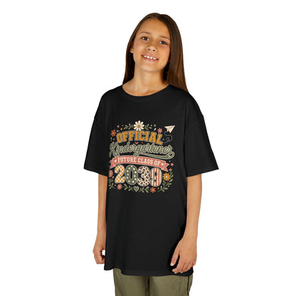 Girl wearing a black TEEZOCA boho Official Kindergartener Future Class of 2039 kids tee, a cute first-day-of-school keepsake shirt.
